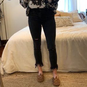Faded/washed black fringe jeans